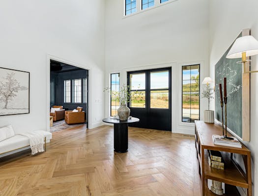 Herringbone wood floors in entryway.